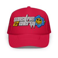 a red trucker hat with a smiley face on it